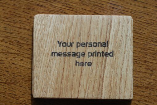 A piece of oak wood printed with "your personal message printed here" in black ink